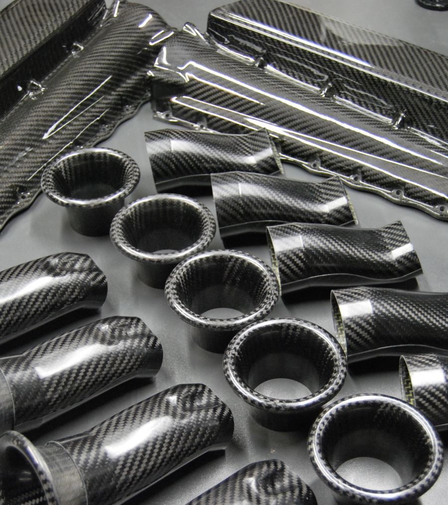 Carbon fiber intake manifold components made by Anubis Composite: plenum shells, runners and flared bellmouths.